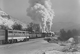 Denver & Rio Grand Western No. 1405 and a 3600-class pushing Carbon County Coal cars at Castle Gate, UT is passed by an e/b F3