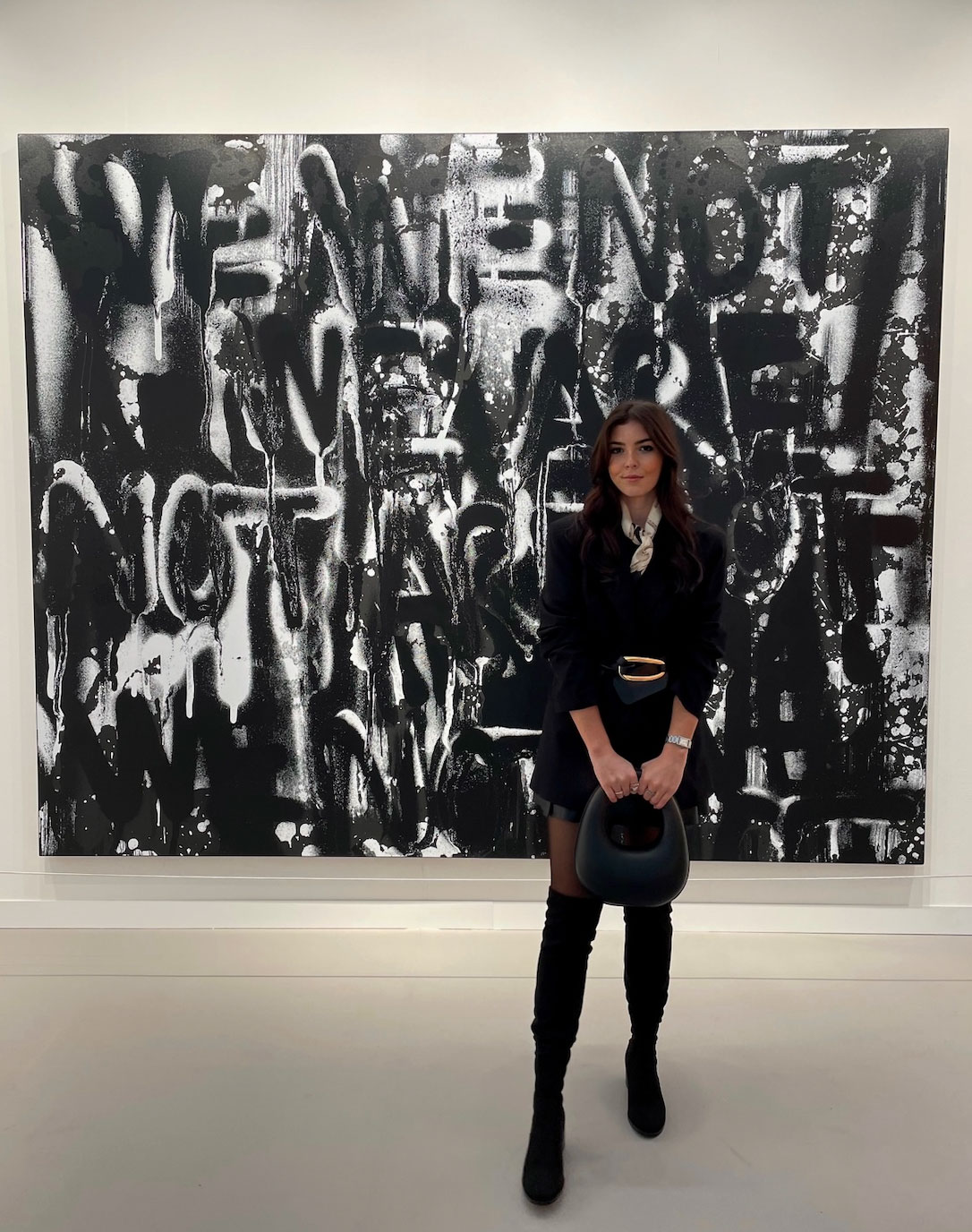 Art history alum Elise Huff (B.A. '20) poses in an art gallery.