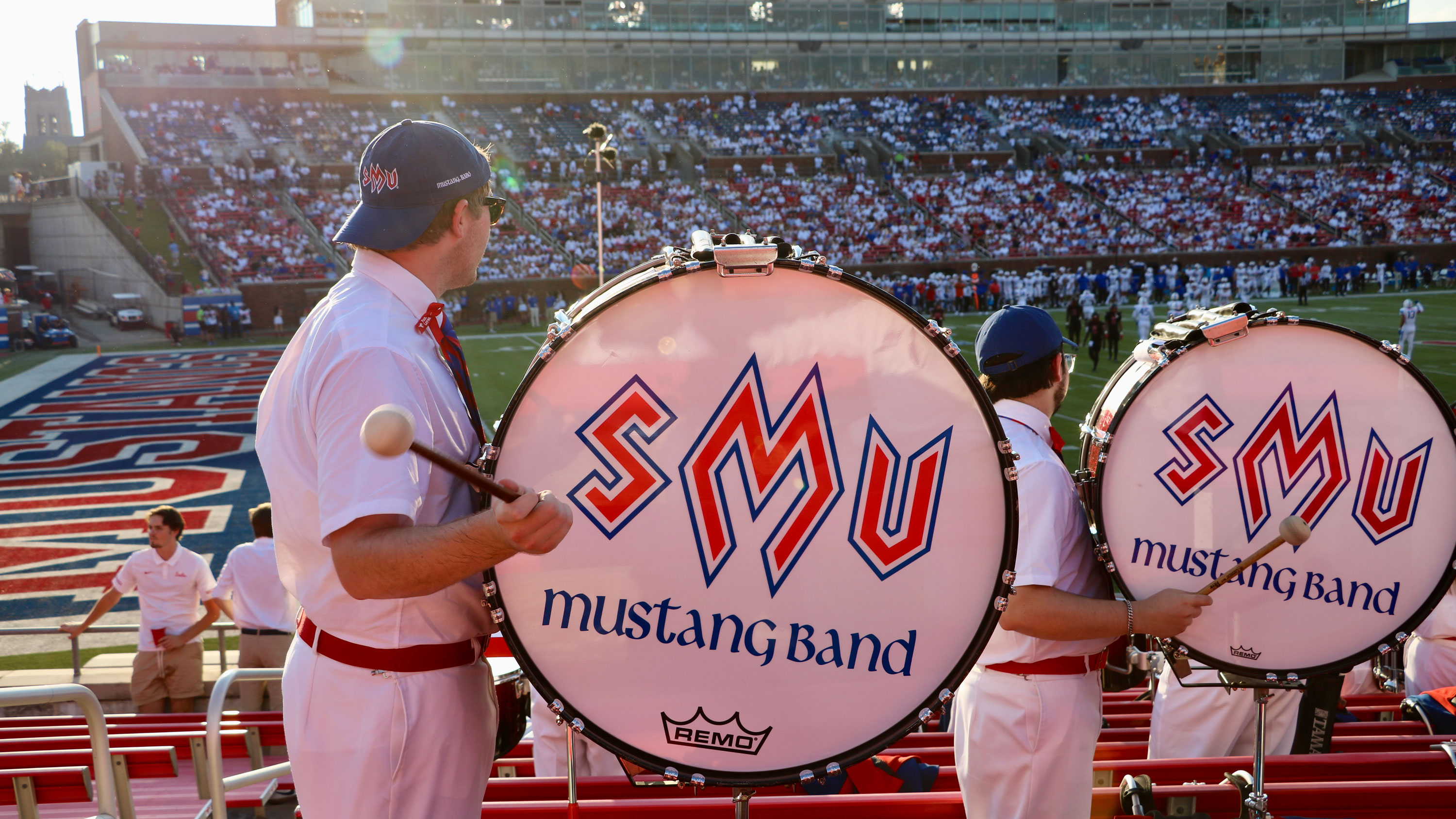 SMU Mustang Band drums with band logo in stands at football game