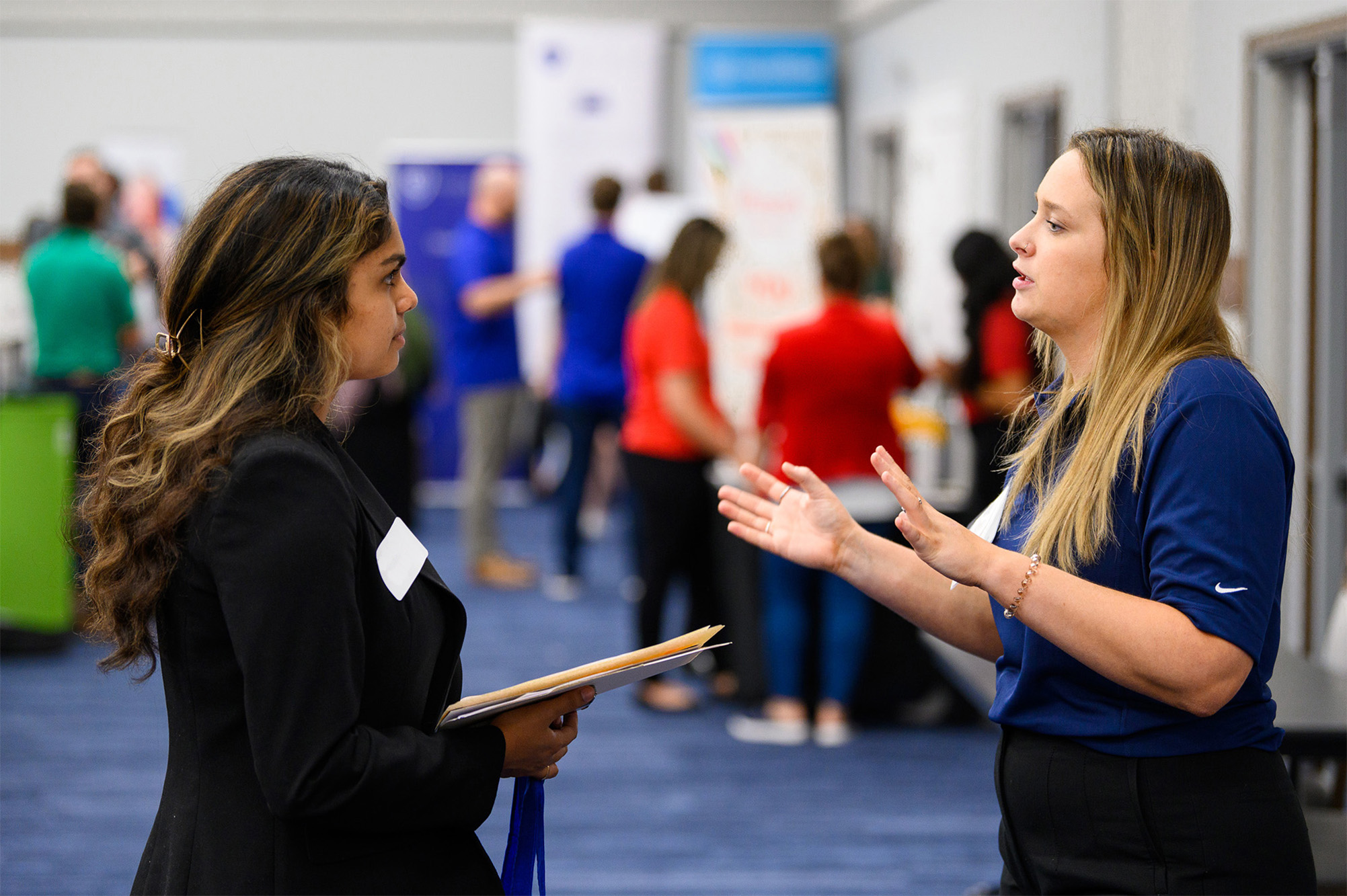 student talking with employer at career fair