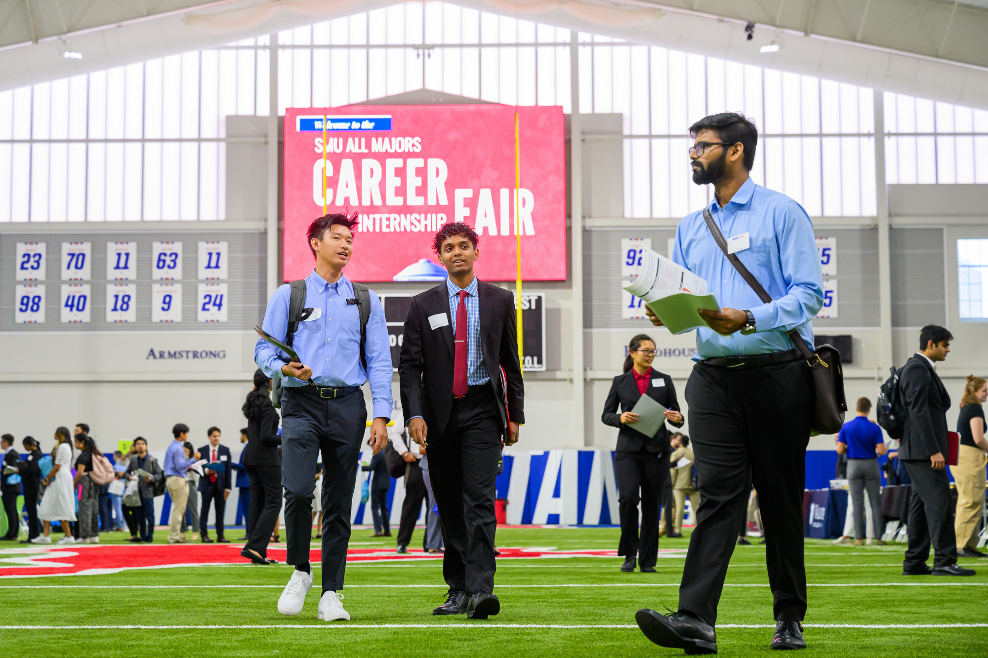 students walking in Armstrong Fieldhouse during career fair