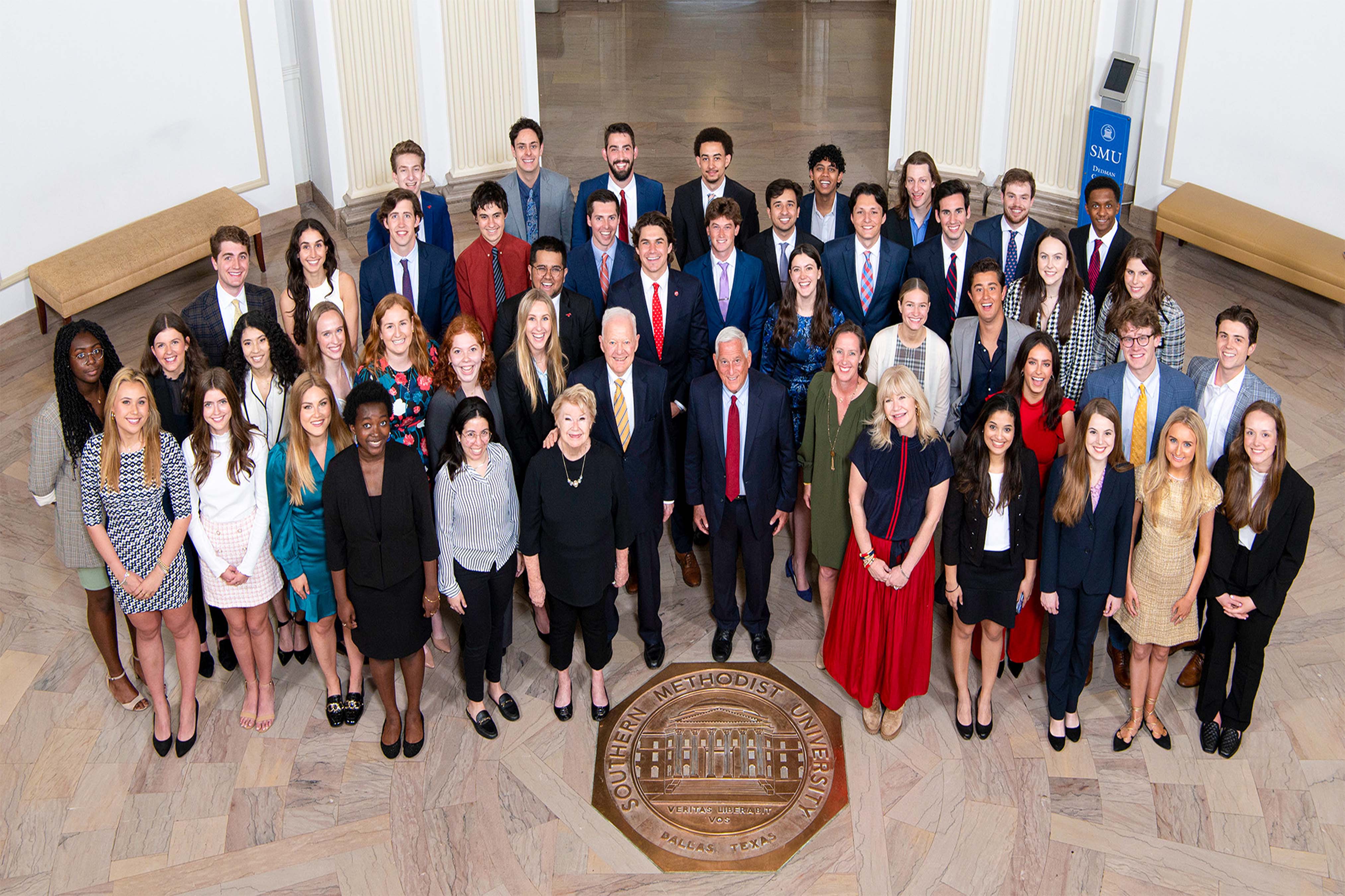 Hunt Scholars with Ray L. and Nancy Ann Hunt and Walter Isaacson standing in Dallas Hall Rotunda