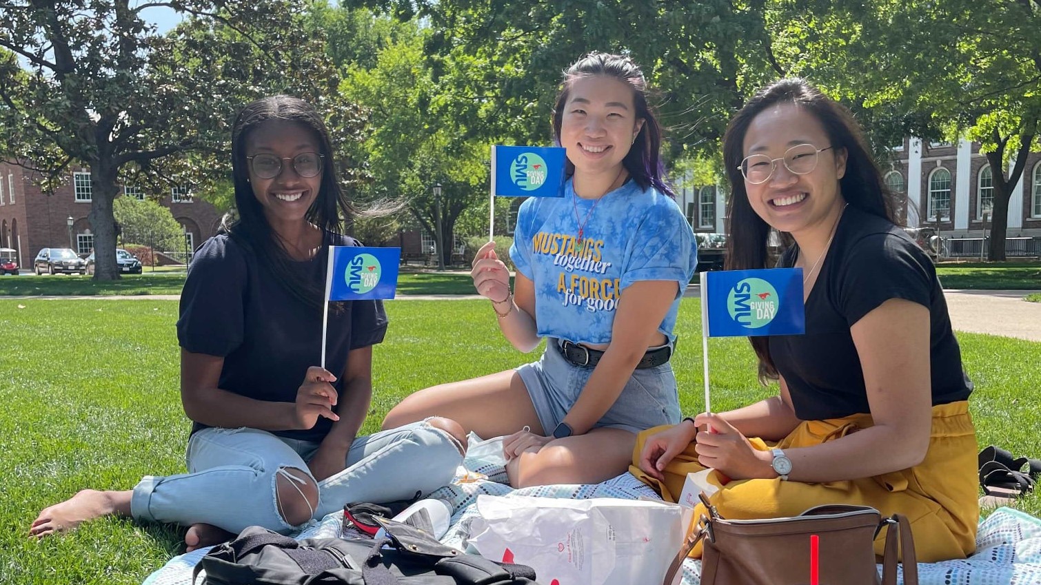 Students sitting on the quad lawn.