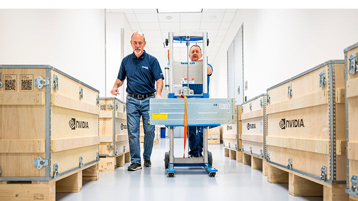 Two people pushing a crate