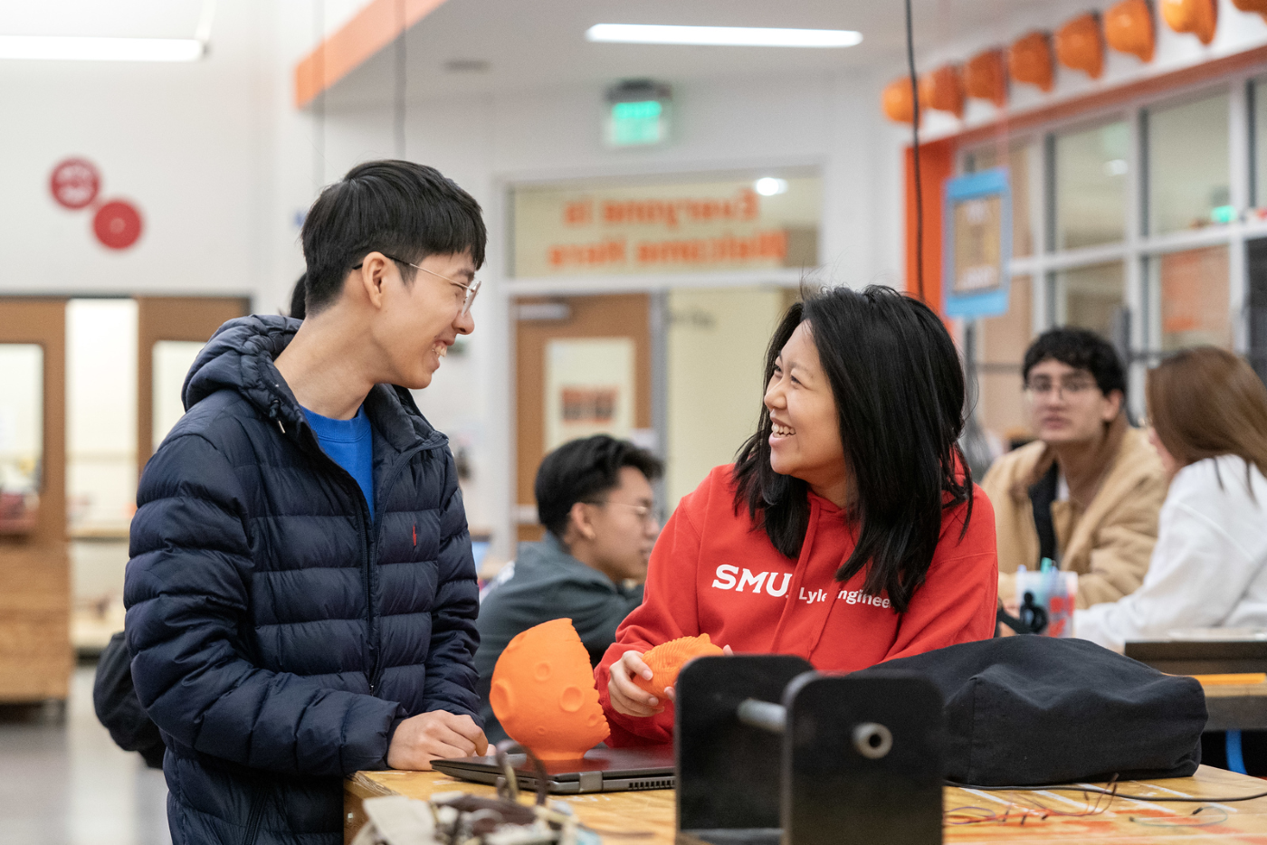 Students interacting over a project in the Deason Innovation Gym