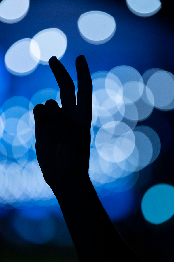 A photo of a hand with fingers in the shape of pony ears.