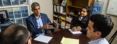 Instructor talking to students around a table