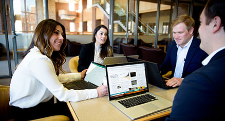 students at desk talking