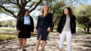 three students walking on campus