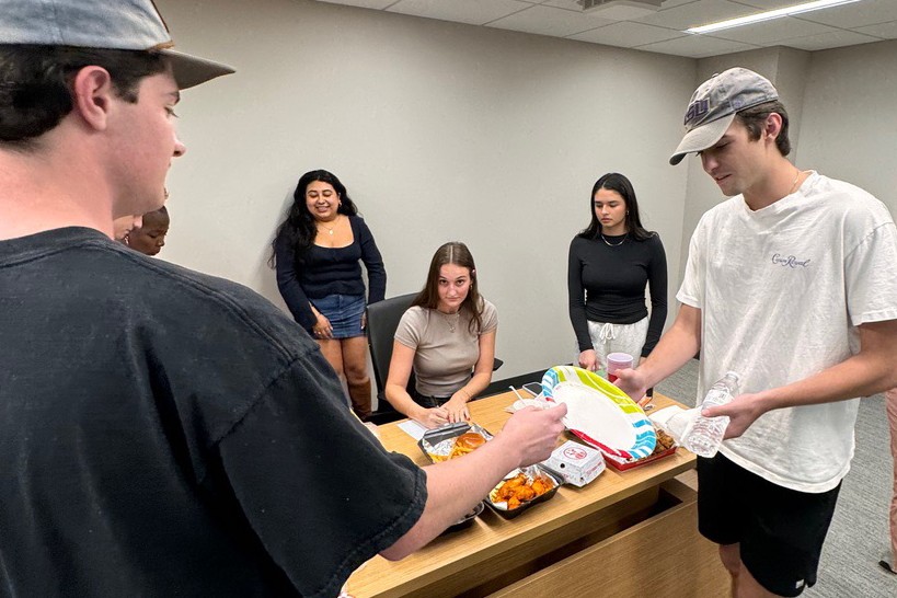 Students taste-test Chick-fil-a items during an experiment run in the Cox Behavioral Lab.