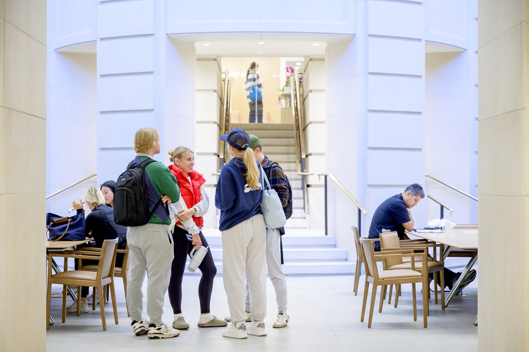 Students gather, chat and work in the Arnold Commons