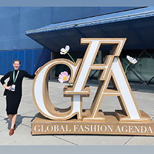 Lacie Thorne poses with a sign for the Global Fashion Agenda