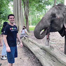 Michael Cogan poses with an elephant in Thailand