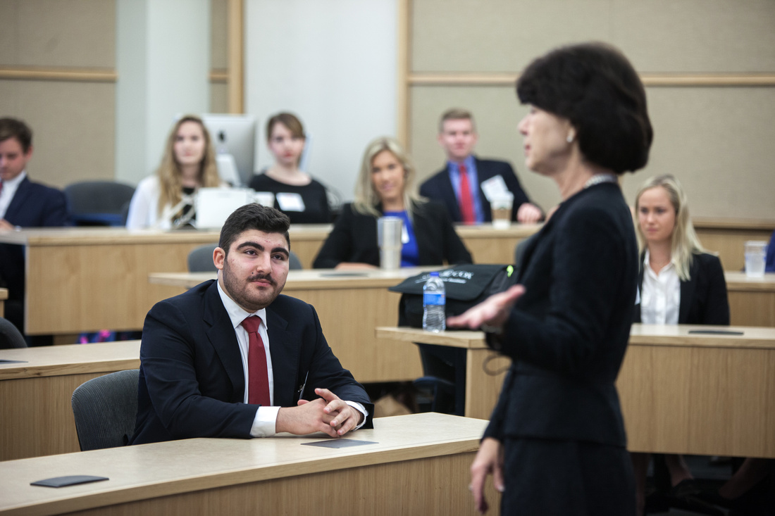 student listens to instructor at smu cox