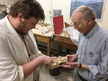 student with faculty in lab