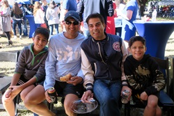 Family celebrates SMU Homecoming at Dedman College Boulevard Tent.