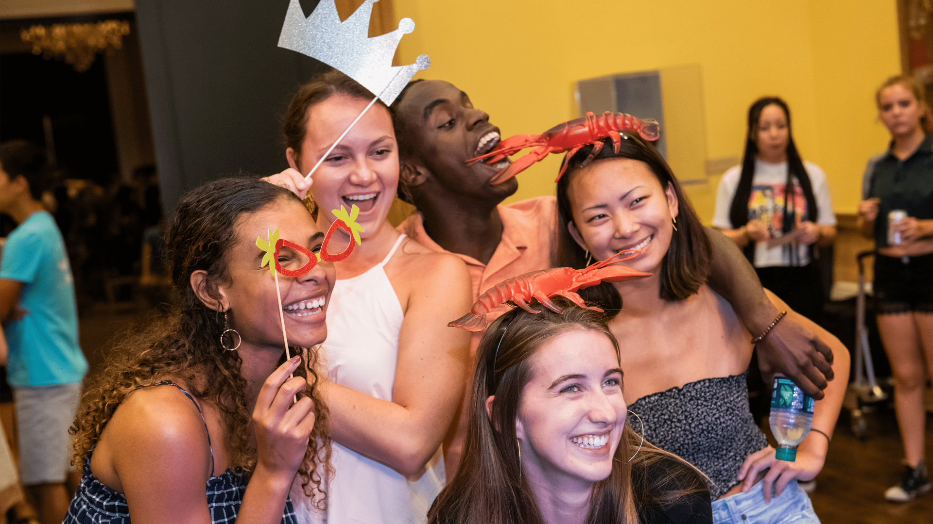 Diverse group of people wearing costumes and smiling for a photo.