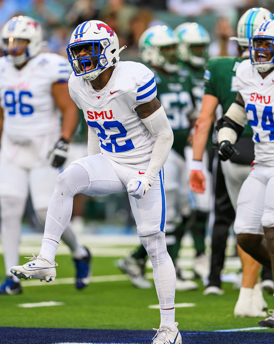 SMU football players exult after a successful play