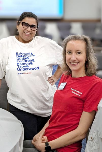 Two library employees smiling