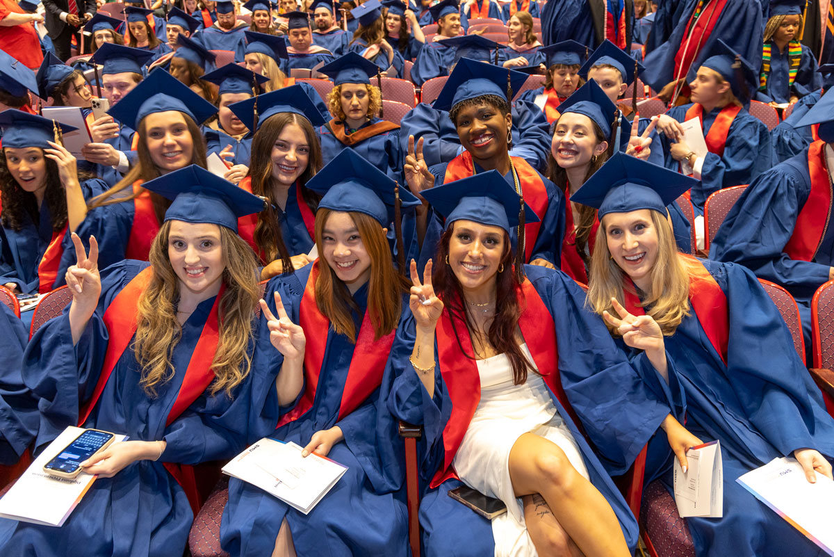 A group of graduates say "pony up!" at the 2023 Degree Recognition Ceremony.