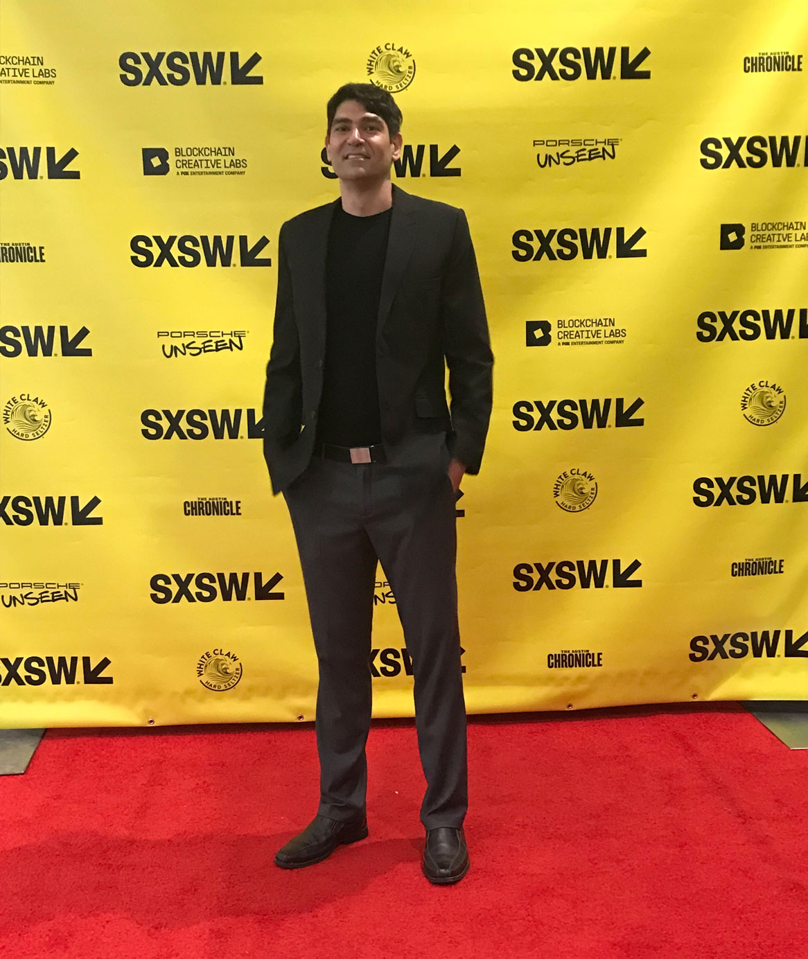 Film & Media Arts alum Bavand Karim poses on the South by Southwest red carpet