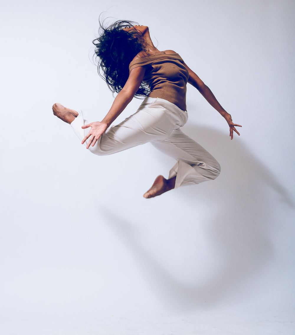 Dance alum Deepa Liegel doing a leap in the air