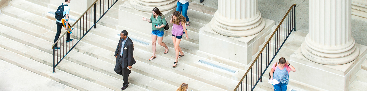 Students walking down the stairs of Dallas Hall to SMU's Main Quad