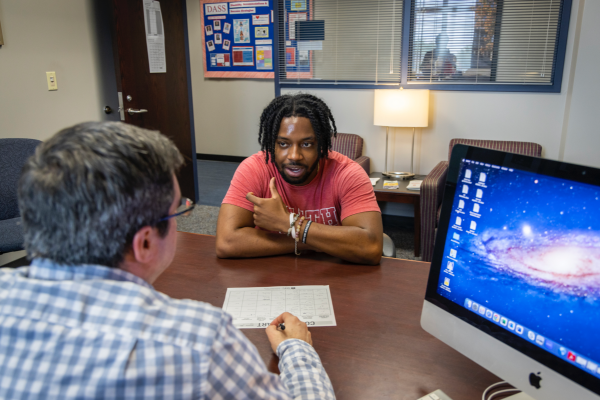 Photo of DASS Learning Specialist in an office working with a student