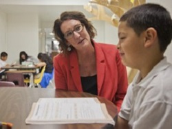 Researcher Dr. Stephanie Al Otaiba with young student.