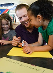 Teacher assisting student with writing exercise