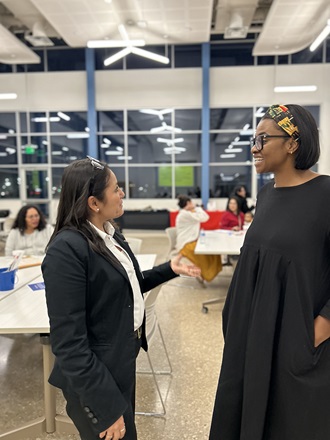 Two people discussing in an office at The Parent Zone, a space for parents in West Dallas to engage in enriching conversations and activities.
