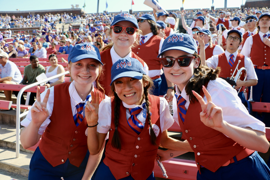 Four and members in Ford Stadium stands