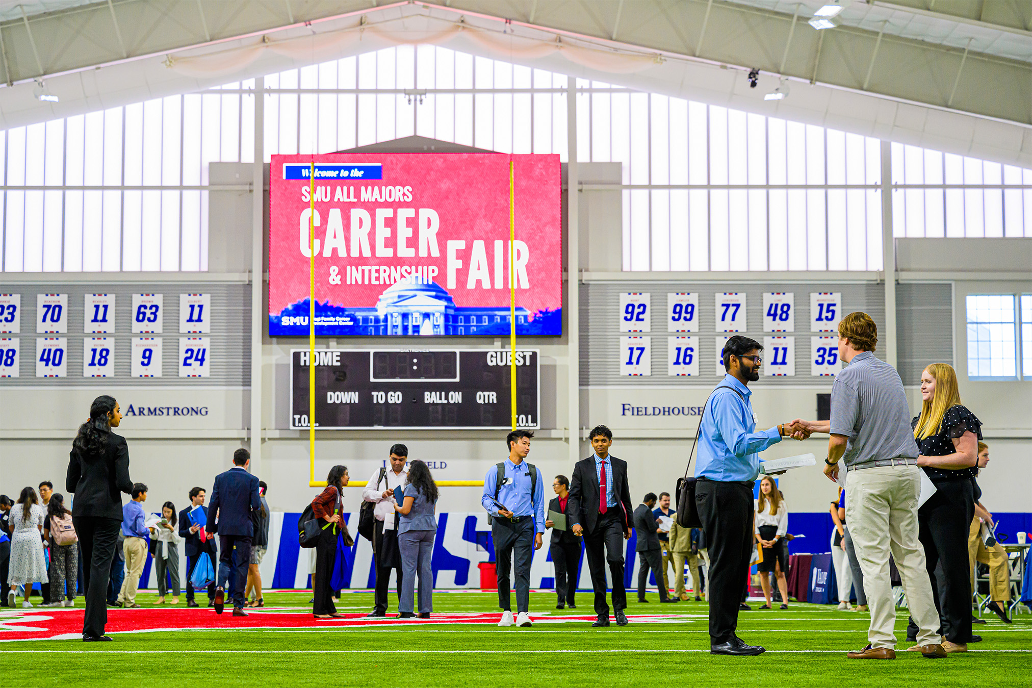 students on indoor football field for career fair