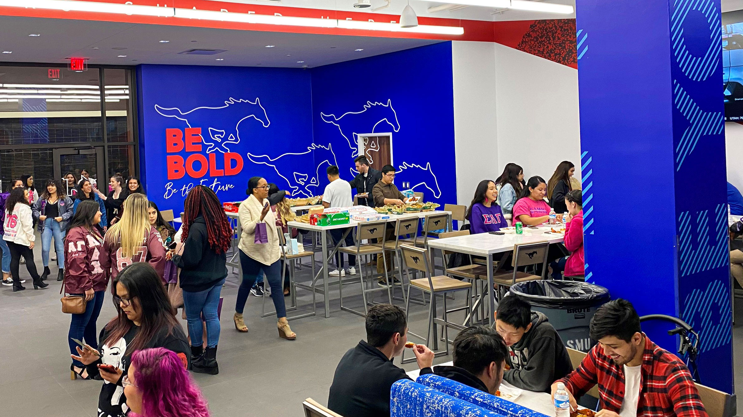 students sitting at tables and walking around The Varsity in Hughes-Trigg Student Center on the SMU campus