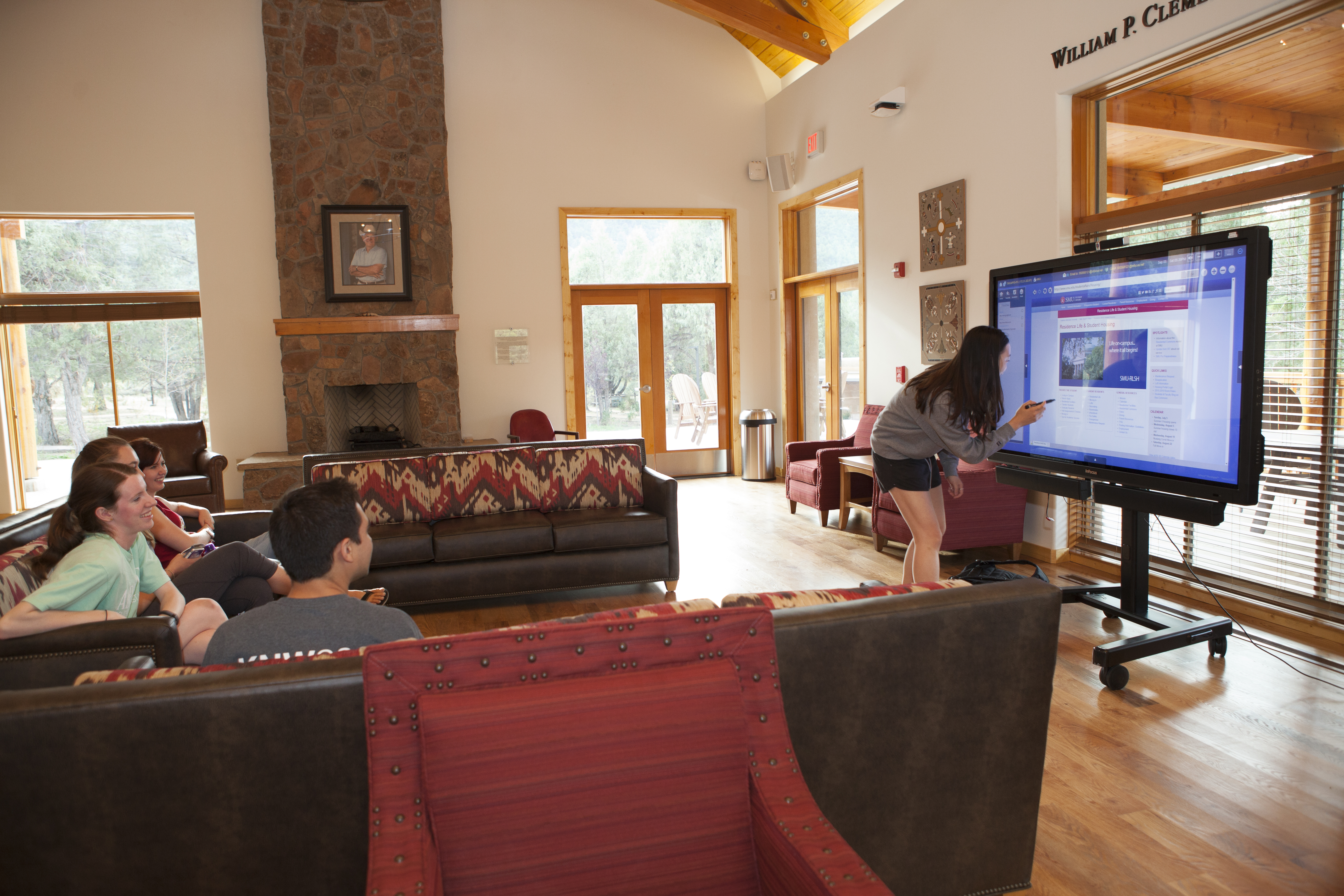 SMU-in-Taos students discuss a project in a common area.