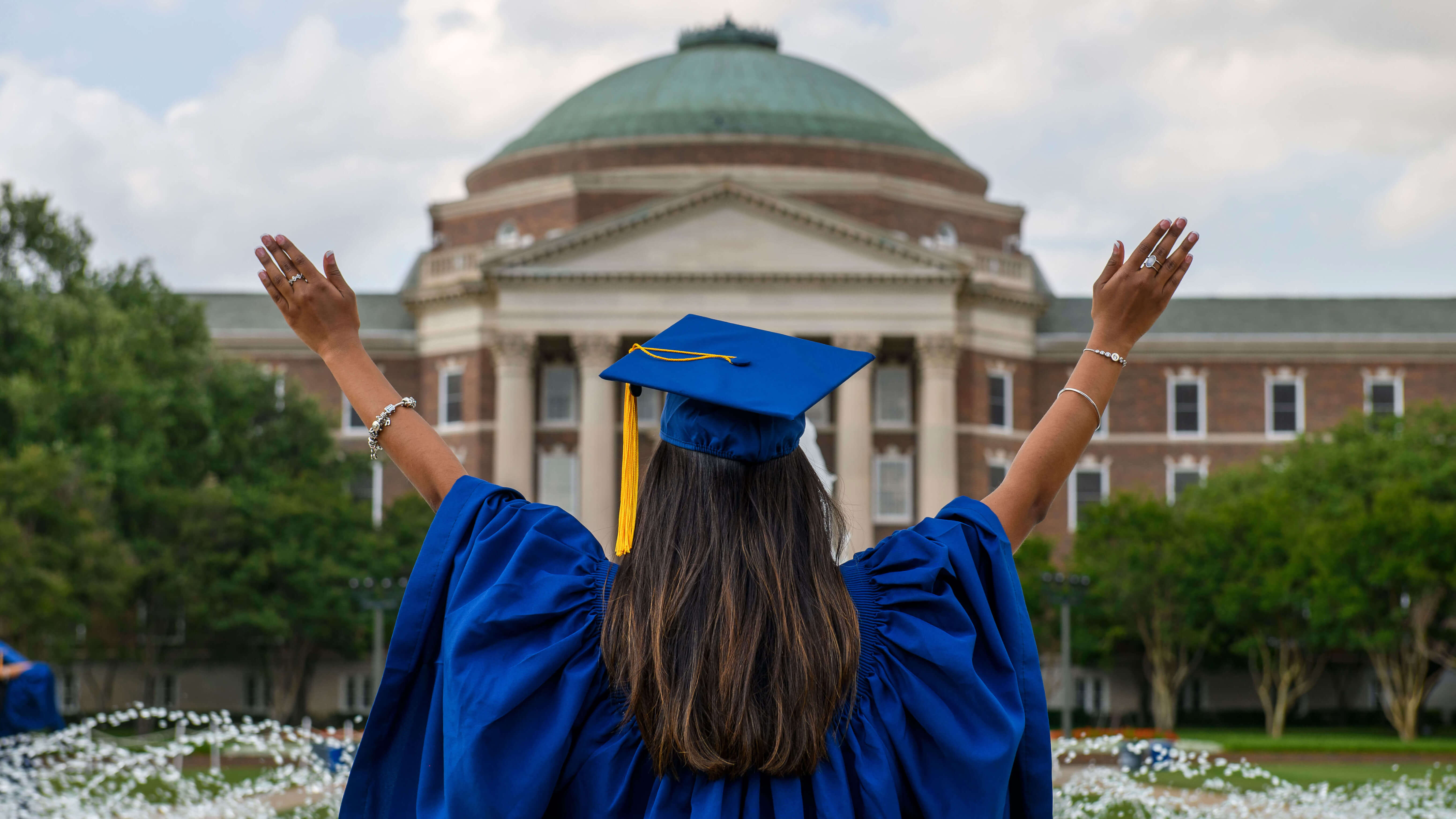 Graduate in front of fountain